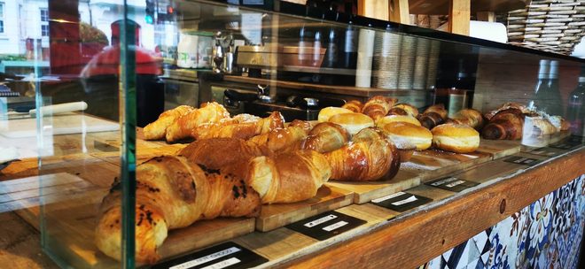 The bakery cabinet of croissants and filled rolls