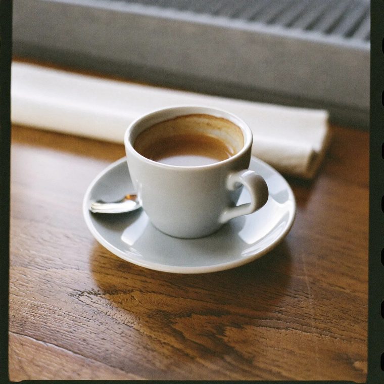An espresso in a plain white cup
